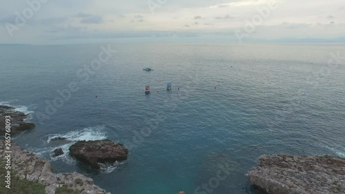 Aerial shot of the Isla Redonda with some boats, Marietas Islands, Nayarit, Mexico photo