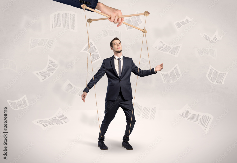 Puppet employee controlled by a big hand with documents and staffs around
Puppet employee controlled by a big hand with documents and staffs around