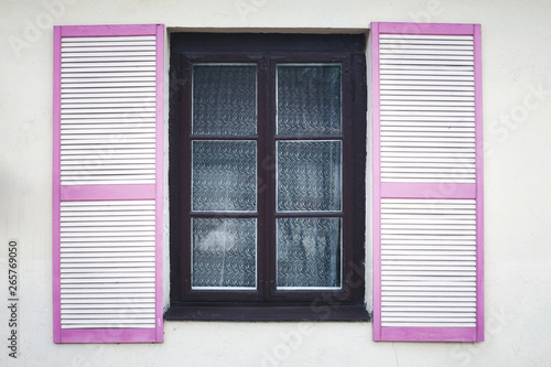 Wooden window shutter. House wall architecture background.