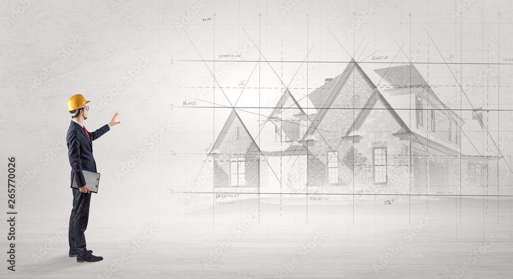 Architect standing and watching an imagined house plan
Architect standing and watching an imagined house plan