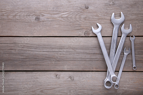 Combination wrenches for repair on grey wooden background