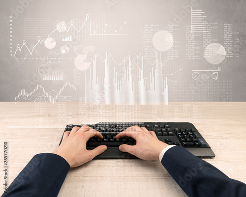 Elegant businessman hand typing with financial, report, graph, chart concept

