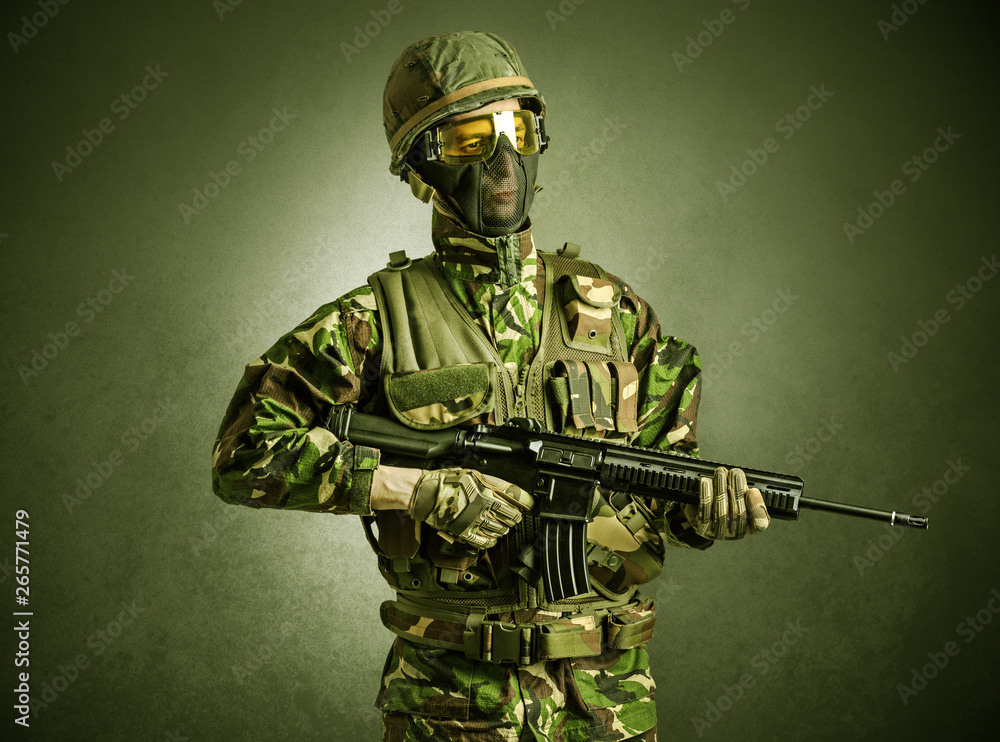 Soldier agent in a dark room with arms on his hand and gas mask
Soldier agent in a dark room with arms on his hand and gas mask