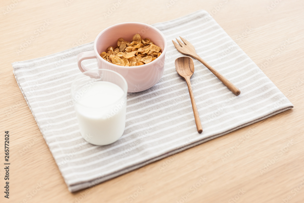cereal with milk on the fabric mat, wood table for breakfast. cereal with milk on the fabric mat, wood table for breakfast.