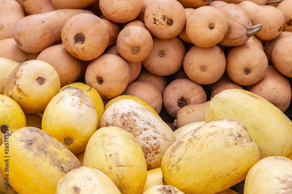 A full frame photograph of squash piled up for sale on a farmers market stall A full frame photograph of squash piled up for sale on a farmers market stall
