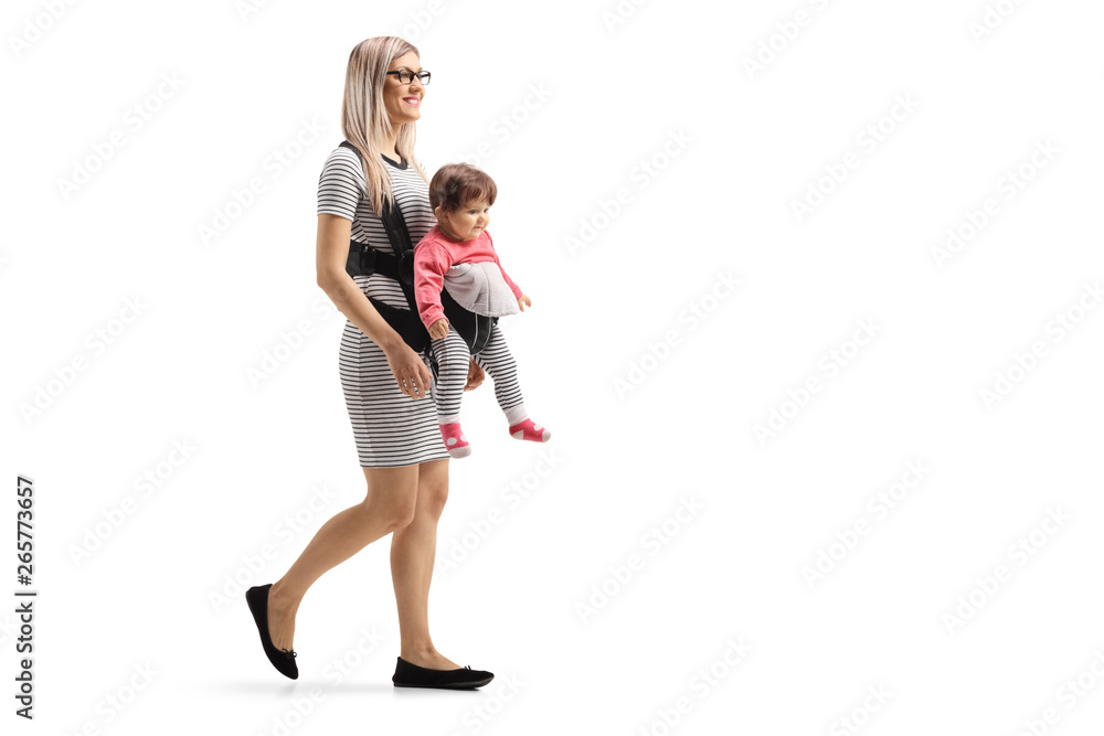 Mother walking with a baby in a carrier Mother walking with a baby in a carrier