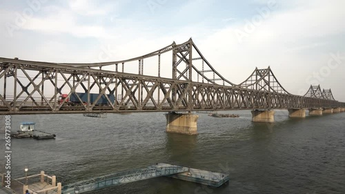 Truck drives over korean chinese friendship bridge from Sinuiju DPRK to Dandong China photo