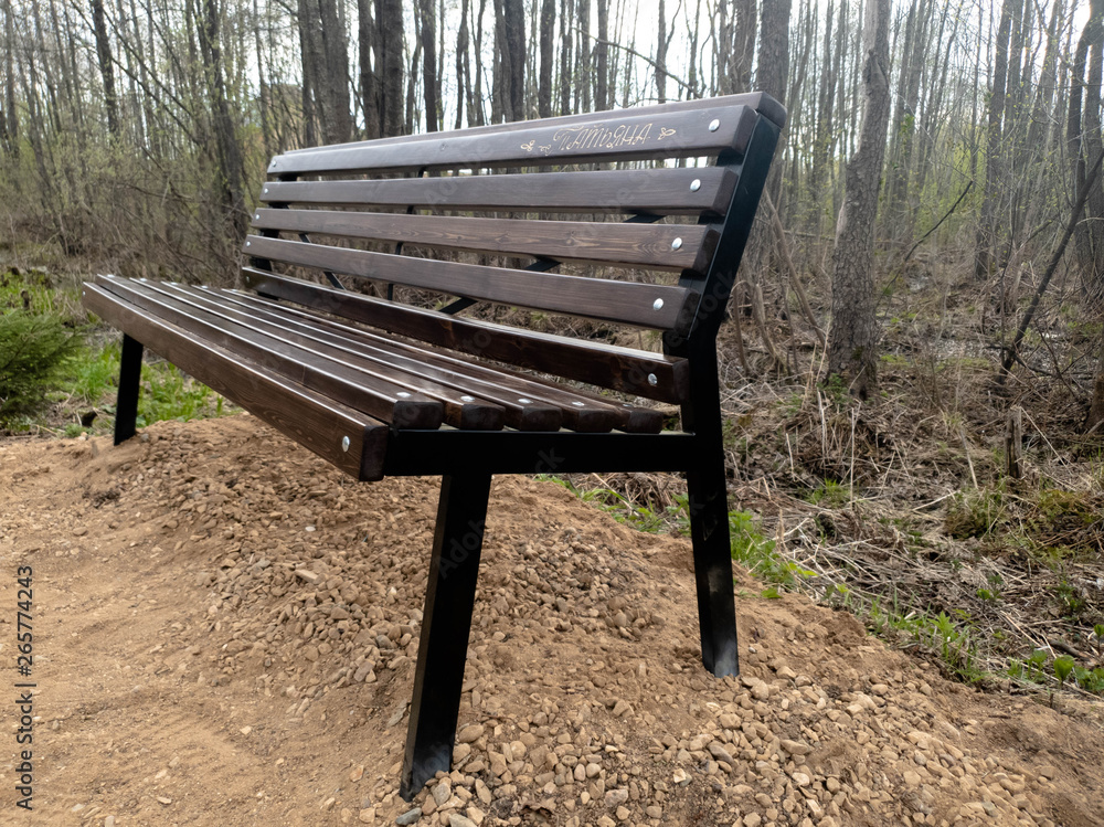 New bench in the park. Wooden park bench. New bench in the park. Wooden park bench.