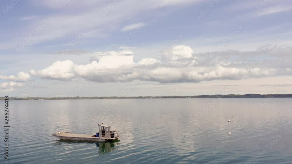 Boat on water drone reveal, clouds and blue sky. Boat on water drone reveal, clouds and blue sky.