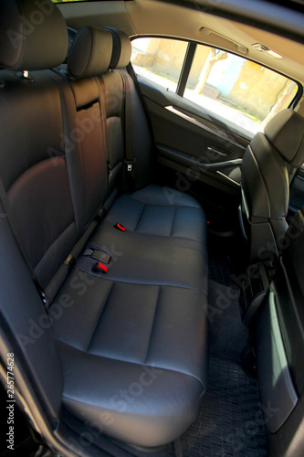 Rear leather seats in the luxury car. © ALYEVA