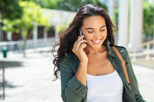 Latin smiling woman talking on phone