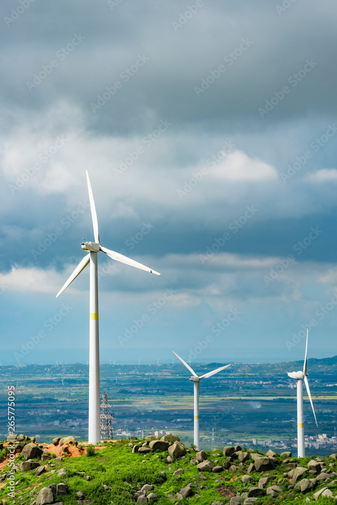 Wind turbines in the mountains near the sea Wind turbines in the mountains near the sea