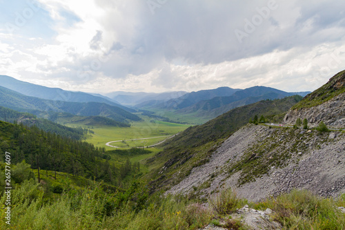 Altai Mountain valley with white clouds. Summer time. Mountain car pass.