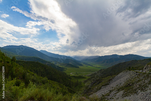 Altai Mountain valley with white clouds. Summer time. Mountain car pass.