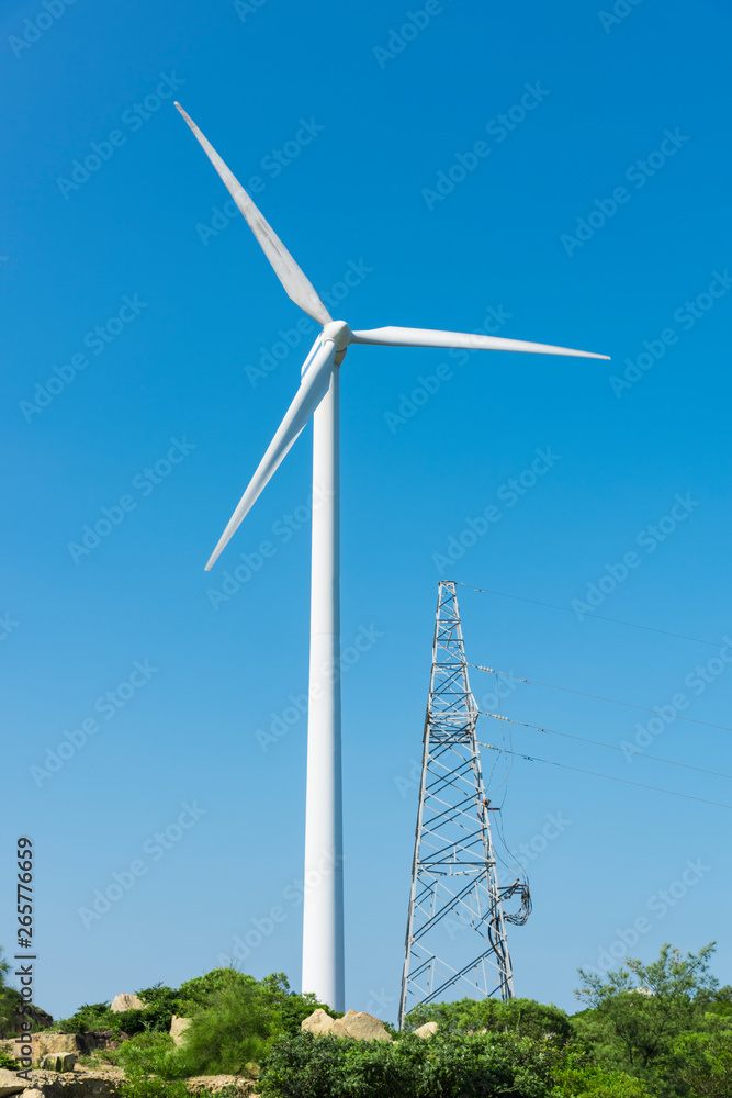 Wind turbines in the mountains near the sea Wind turbines in the mountains near the sea
