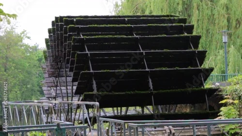 wheel with blades rotates from the flow of water