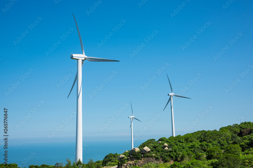 Wind turbines in the mountains near the sea Wind turbines in the mountains near the sea
