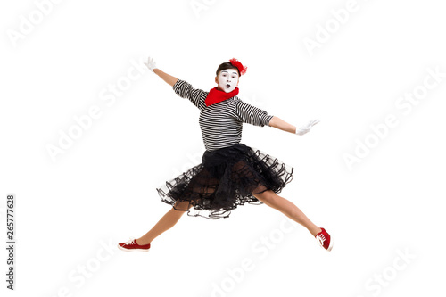 Full length portrait of mime woman artist jumping isolated on white background