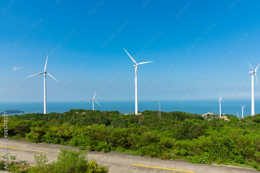 Wind turbines in the mountains near the sea Wind turbines in the mountains near the sea