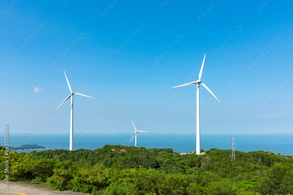 Wind turbines in the mountains near the sea Wind turbines in the mountains near the sea