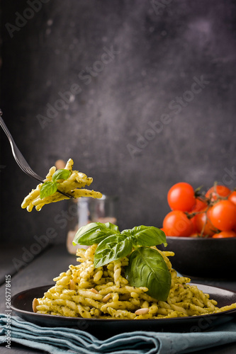 Traditional Italian pasta trofie with basil, garlic, parmesan and olive oil. Homemade food. photo