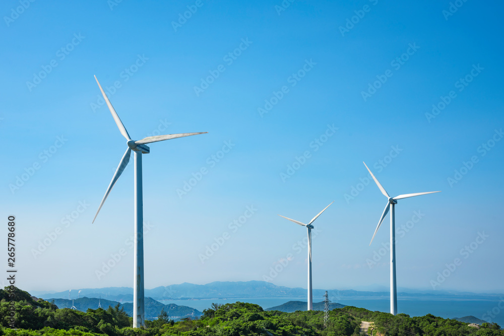 Wind turbines in the mountains near the sea Wind turbines in the mountains near the sea