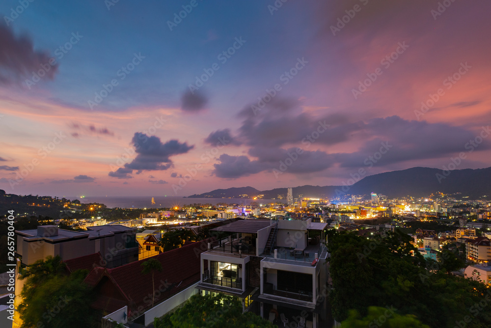 The beautiful sky at sunset and the lights of the city of Phuket 