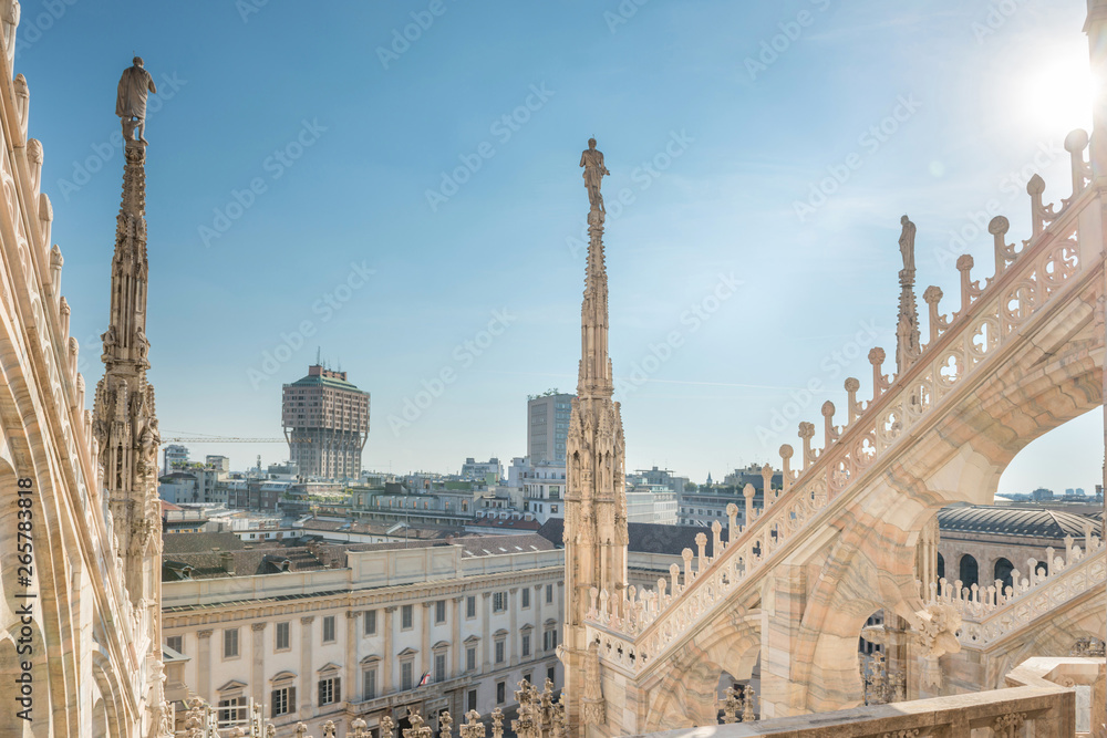 View from roof of Duomo to spires with statues and sity of Milan