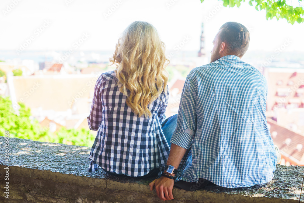 Naklejka premium Young loving couple traveling to Tallinn. Love, relations and tourism concept.