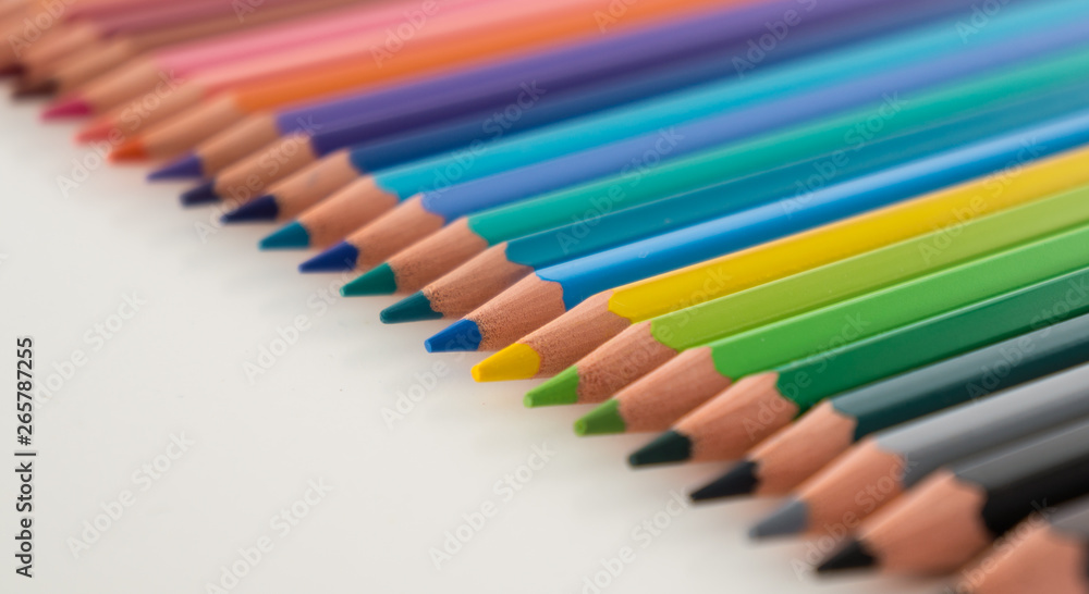 Closeup of coloured pencils lined up in a row Closeup of coloured pencils lined up in a row