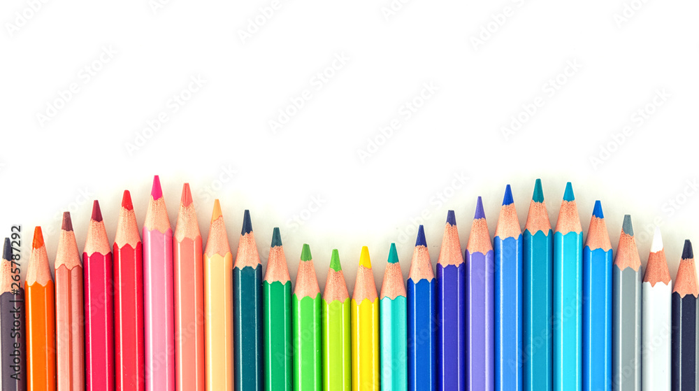 Closeup of coloured pencils lined up in a row on white background copy space Closeup of coloured pencils lined up in a row on white background copy space
