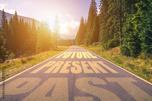 Past, Present, Future concept. Driving on an empty road in the mountains to the Future passing Present and leaving behind the Past. photo