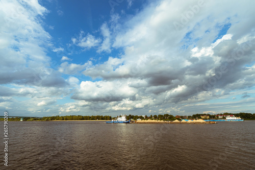 tugboat pushing a barge along the river