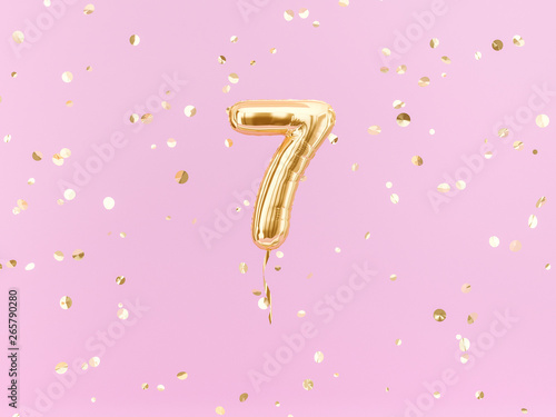Seven year birthday. Number 7 flying foil balloon on pink. Seven-year anniversary gold confetti background. 3d rendering
