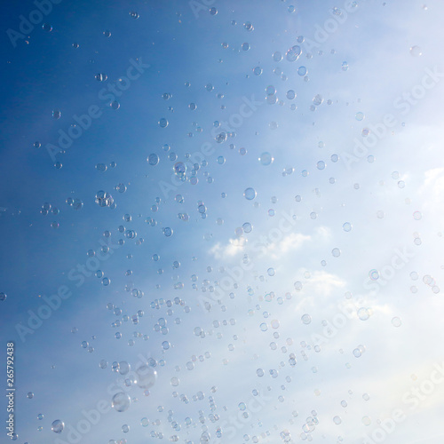 Soap bubbles fly in the blue sky