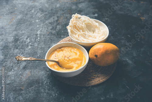 Aam Ras or Alphonso mango pulp with kurdai which is a fried dish made using wheat/gehu. selective focus photo