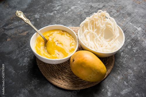 Aam Ras or Alphonso mango pulp with kurdai which is a fried dish made using wheat/gehu. selective focus photo