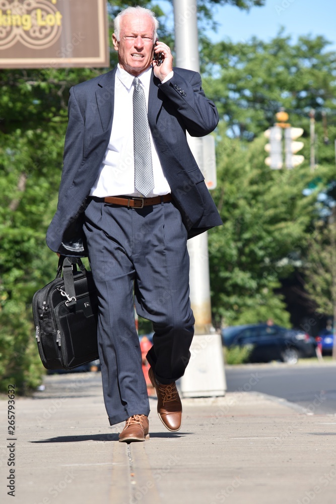 Adult Senior Business Man Using Cell Phone Wearing Business Suit Walking Adult Senior Business Man Using Cell Phone Wearing Business Suit Walking