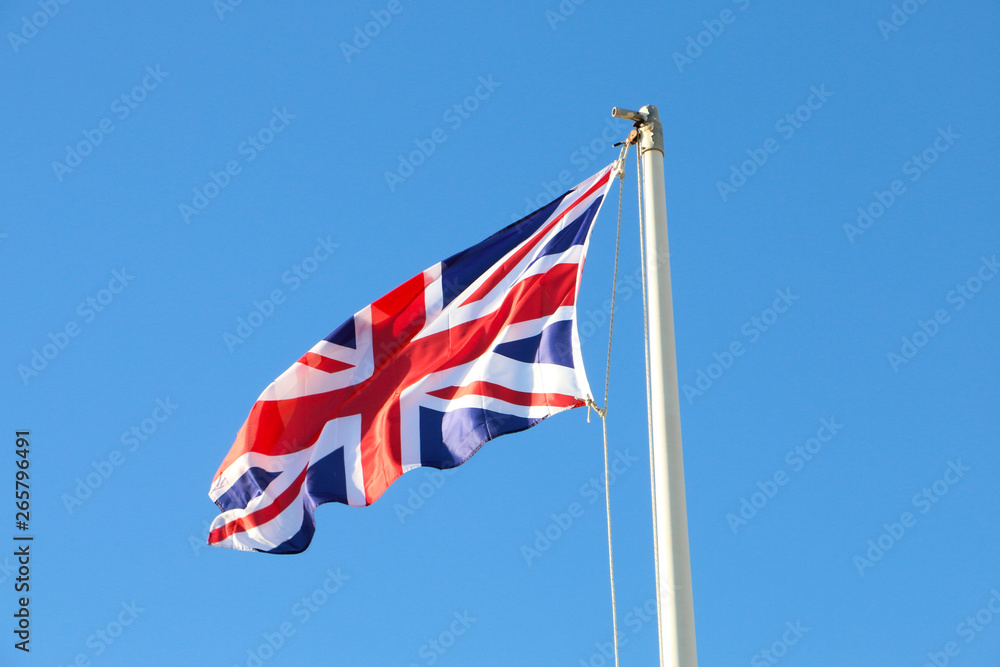 British flag flyng, on a beautiful blue sky day 