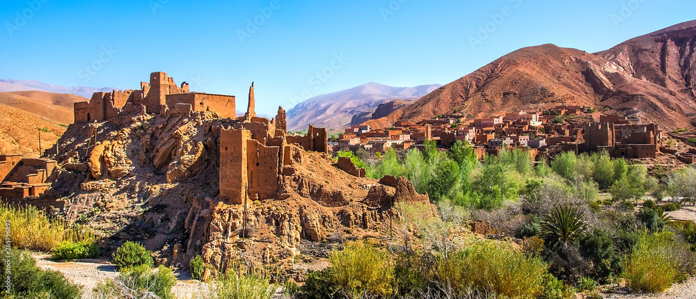 Amazing view of a Kasbah's ruin on the way to Kasbah Ait Ben Haddou near Ouarzazate in the Atlas Mountains of Morocco. Artistic picture. Beauty world. Panorama