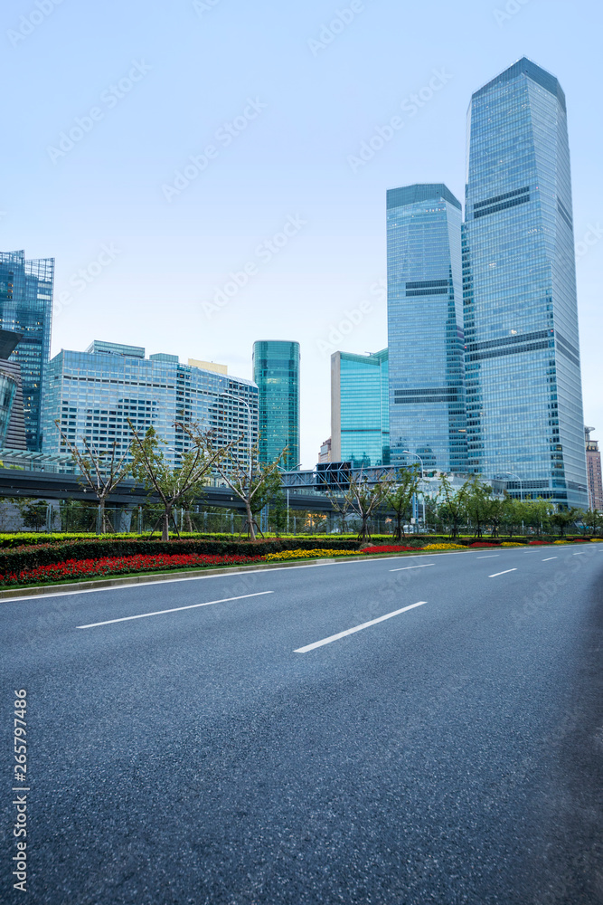 The pedestrian pavement under the tall building large building.