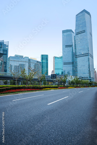 The pedestrian pavement under the tall building large building.