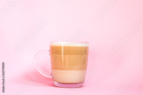 Hot coffee latte transparent glass cup on pink background