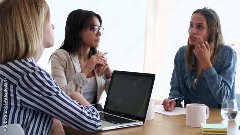 Three business colleagues working together in modern workspace. Brainstorming concept. Three business colleagues working together in modern workspace. Brainstorming concept.