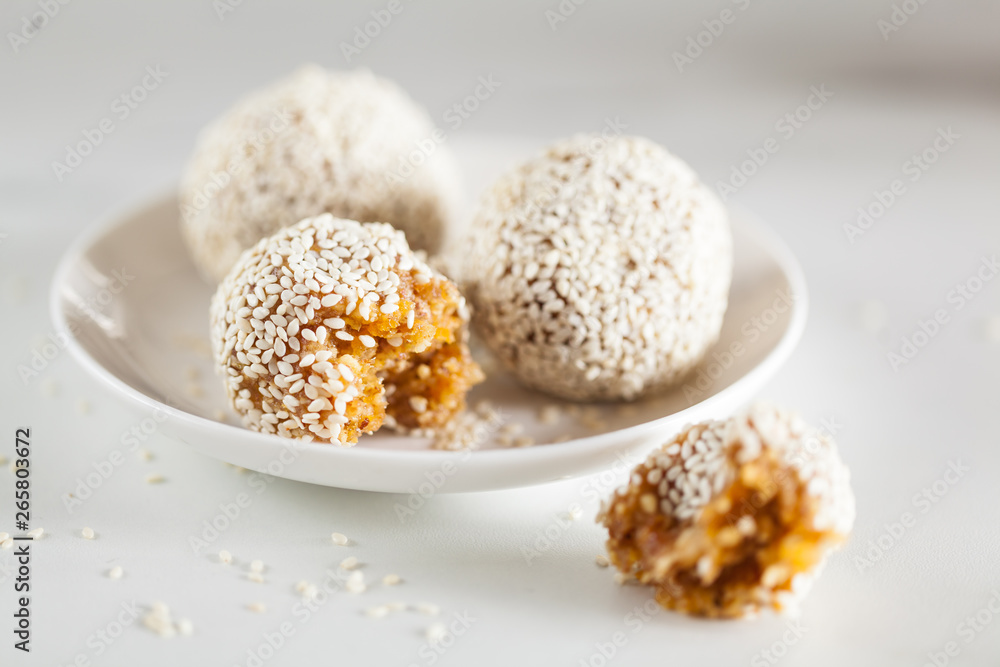 Healthy energy balls made of dried fruits and nuts with sesame. Raw vegan candy.