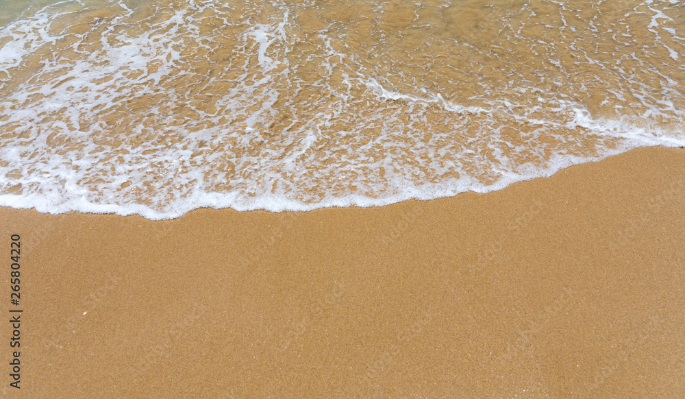 Blue ocean wave on sandy beach. Soft wave of blue ocean on sandy beach. Background. Top view of Beautiful beach with tranquil wave, sea and ocean background, summer vacation concept. Blue ocean wave on sandy beach. Soft wave of blue ocean on sandy beach. Background. Top view of Beautiful beach with tranquil wave, sea and ocean background, summer vacation concept.