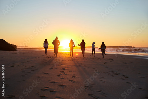 Running friends on beach