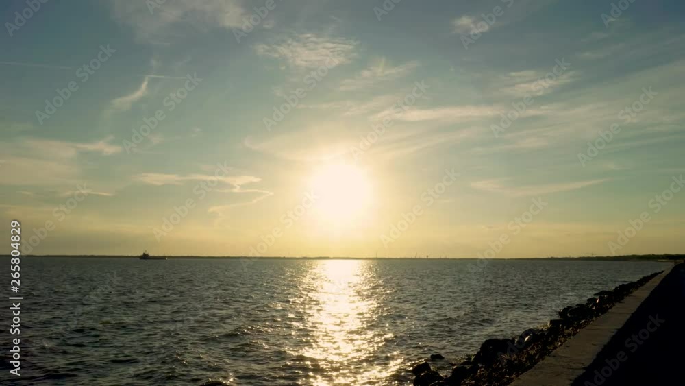 Golden sunset on the coast and coastal walkways ,Sunset at sea and beautiful clouds Golden sunset on the coast and coastal walkways ,Sunset at sea and beautiful clouds