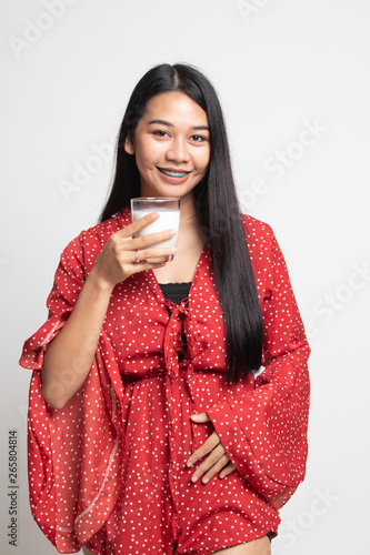 Healthy Asian woman drinking a glass of milk.