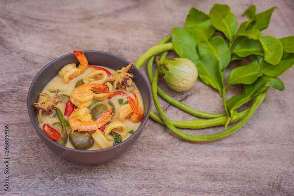 Thai food chicken green curry on dark wooden background. top view Thai food chicken green curry on dark wooden background. top view